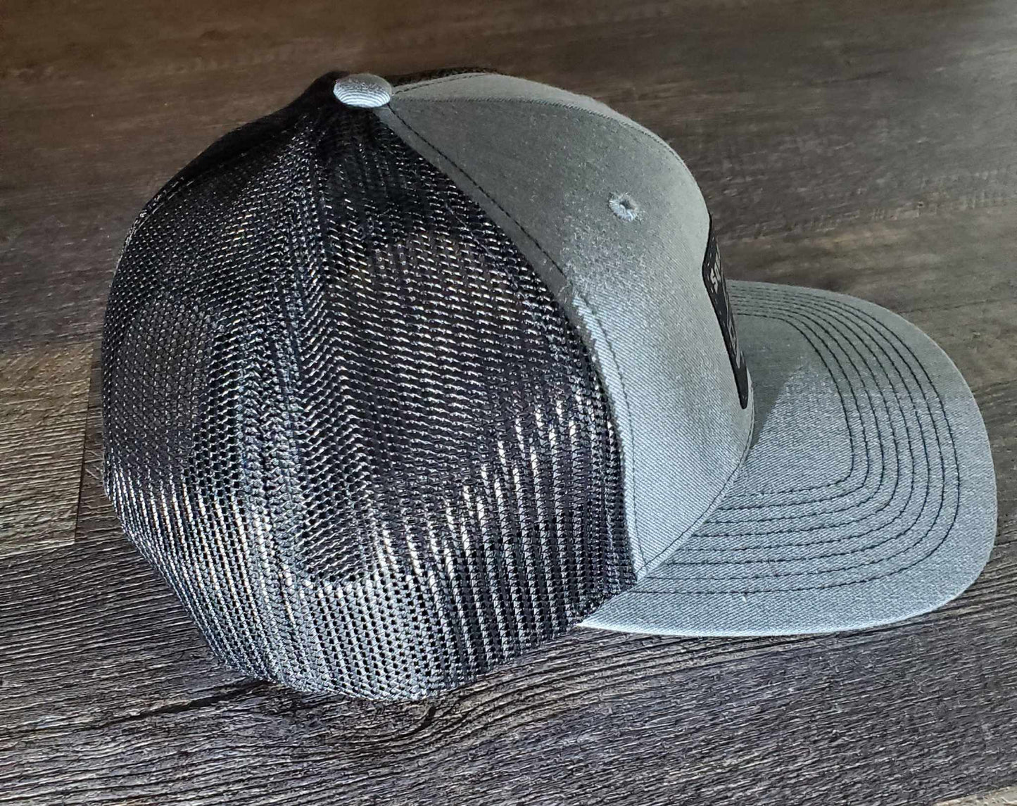 Squarebody Stuff Grey and black mesh snap back cap.